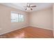 Bedroom with laminate wood flooring and a window at 11029 W Meade Dr, Sun City, AZ 85351