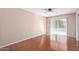 Bedroom with laminate wood flooring and sliding glass door at 11029 W Meade Dr, Sun City, AZ 85351