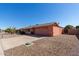 Single story home with peach stucco exterior, two-car garage, and desert landscaping at 11029 W Meade Dr, Sun City, AZ 85351