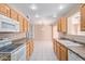 Kitchen with light wood cabinets and tile flooring at 11029 W Meade Dr, Sun City, AZ 85351