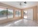 Bright sunroom with backyard access and tile flooring at 11029 W Meade Dr, Sun City, AZ 85351