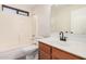 Clean bathroom with wood vanity, updated fixtures, and a bathtub at 11465 W Virginia Ave, Avondale, AZ 85392