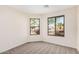 Bright bedroom with large windows and neutral carpeting at 11465 W Virginia Ave, Avondale, AZ 85392