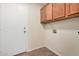 Laundry room with upper cabinets and tiled flooring at 11465 W Virginia Ave, Avondale, AZ 85392