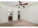 Bedroom with ceiling fan, carpet, and en-suite bathroom access at 1151 E Stardust Way, San Tan Valley, AZ 85143