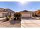 House exterior featuring a two-car garage and desert landscaping at 1151 E Stardust Way, San Tan Valley, AZ 85143