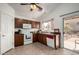 Kitchen with wood cabinets, white appliances, and access to backyard at 1151 E Stardust Way, San Tan Valley, AZ 85143