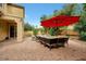 Outdoor patio area with seating, umbrella, and water feature at 1188 W Laredo Ave, Gilbert, AZ 85233