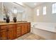 Bathroom with soaking tub, double vanity, and granite countertops at 1188 W Laredo Ave, Gilbert, AZ 85233