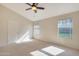 Bright bedroom with high ceilings, ceiling fan and two windows at 1207 W Sea Bass Ct, Gilbert, AZ 85233