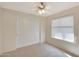 Well-lit bedroom with double-door closet and ceiling fan at 1207 W Sea Bass Ct, Gilbert, AZ 85233