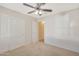 Bedroom featuring double-door closet and ceiling fan at 1207 W Sea Bass Ct, Gilbert, AZ 85233