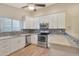 Modern kitchen with white cabinets, stainless steel appliances, and tile backsplash at 1207 W Sea Bass Ct, Gilbert, AZ 85233