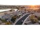 Aerial view of community with houses, streets, and a golf course at 14335 W Monte Vista Rd, Goodyear, AZ 85395