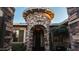 Elegant home exterior with a stone facade and arched entryway at 14335 W Monte Vista Rd, Goodyear, AZ 85395