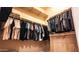 Large walk-in closet with shelves and hanging rods at 14335 W Monte Vista Rd, Goodyear, AZ 85395