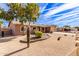 Tan house with a two-car garage and cactus landscaping at 14409 N 34Th Way, Phoenix, AZ 85032