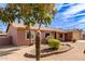 Tan house with a two-car garage and cactus landscaping at 14409 N 34Th Way, Phoenix, AZ 85032