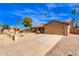 Tan house with a two-car garage and gravel driveway at 14409 N 34Th Way, Phoenix, AZ 85032