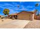 Tan house with a two-car garage and desert landscaping at 14409 N 34Th Way, Phoenix, AZ 85032