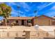 Tan house with a two-car garage and a landscaped front yard at 14409 N 34Th Way, Phoenix, AZ 85032