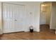 Hallway with wood floors, closet with paneled doors, and view of doorway to another room at 15034 N 30Th St, Phoenix, AZ 85032