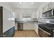 Modern kitchen with stainless steel appliances and white cabinets at 15034 N 30Th St, Phoenix, AZ 85032