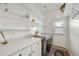 Bright laundry room with washer, dryer, and ample shelving at 15034 N 30Th St, Phoenix, AZ 85032