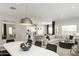 Open concept dining room with a large white table and modern lighting at 15056 W Gray Fox Trl, Surprise, AZ 85387