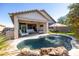 Landscaped backyard with covered patio, pool, grassy area and lush plants at 15804 N 109Th Dr, Sun City, AZ 85351