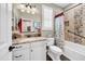 Well-lit bathroom with granite countertop, white cabinets, and a tub with shower at 15804 N 109Th Dr, Sun City, AZ 85351