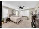 Bright bedroom featuring a ceiling fan, neutral walls, plantation shutters, and carpeted floors at 15804 N 109Th Dr, Sun City, AZ 85351