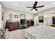 Spacious bedroom with neutral carpet, ceiling fan, and abundant closet space at 15804 N 109Th Dr, Sun City, AZ 85351