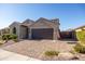 Charming single-story home with a well-manicured yard and a brick driveway, American flag, and neutral tones at 15804 N 109Th Dr, Sun City, AZ 85351