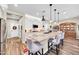 Bright kitchen island and seating, adjacent to the foyer and open to additional living space at 15804 N 109Th Dr, Sun City, AZ 85351