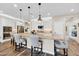 Modern kitchen with stainless steel appliances, a large island with seating, and pendant lighting at 15804 N 109Th Dr, Sun City, AZ 85351