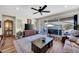 Bright living room with sliding glass doors to outdoor living and ceiling fan at 15804 N 109Th Dr, Sun City, AZ 85351