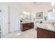 Double vanity bathroom with granite countertops and large mirrors at 16247 S 180Th Dr, Goodyear, AZ 85338