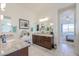 Spacious bathroom with dual vanities, granite countertops, and a view of the bedroom at 16247 S 180Th Dr, Goodyear, AZ 85338