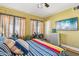 Bedroom with a ceiling fan, two windows, a TV, and an accent chair at 1638 E Earll Dr, Phoenix, AZ 85016