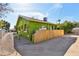 Side view of a green one-story home with a bamboo fence and gravel landscaping at 1638 E Earll Dr, Phoenix, AZ 85016