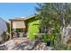 View of the green home, showing an outdoor deck, shade coverings, and drought-resistant landscaping at 1638 E Earll Dr, Phoenix, AZ 85016