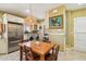 Open kitchen area featuring stainless steel appliances, a dining table, and convenient laundry at 1638 E Earll Dr, Phoenix, AZ 85016