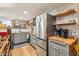 Modern kitchen with stainless steel appliances, wood countertops, and stylish shelving at 1638 E Earll Dr, Phoenix, AZ 85016