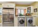 Convenient laundry area adjacent to the kitchen with stainless steel appliances and ample counter space at 1638 E Earll Dr, Phoenix, AZ 85016