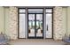 Elegant entryway with glass doors, stone accents, and modern light fixtures at 16770 W Alameda Rd, Surprise, AZ 85387