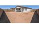 Spacious backyard with a blank canvas for landscaping, enclosed by a block wall for privacy at 17399 W Whispering Wind Dr, Surprise, AZ 85387