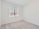 Neutral bedroom with plush carpeting and a window providing natural light at 17399 W Whispering Wind Dr, Surprise, AZ 85387