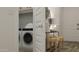 Laundry room with washer, dryer, and additional storage at 17399 W Whispering Wind Dr, Surprise, AZ 85387