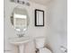 Clean bathroom with pedestal sink and toilet at 1777 S Balboa Dr, Gilbert, AZ 85295